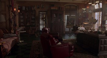 Movie still from “Get Shorty” (1995), directed by Barry Sonnenfeld – A living room filled with furniture and a large window; Wide shot, High angle