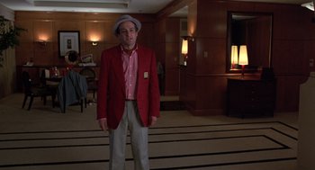 Movie still from “Get Shorty” (1995), directed by Barry Sonnenfeld – A man wearing a red jacket and a hat; Medium shot, Low angle