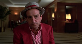Movie still from “Get Shorty” (1995), directed by Barry Sonnenfeld – A man wearing a red jacket and a hat; Close Up shot, Low angle