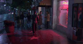 Movie still from “Get Shorty” (1995), directed by Barry Sonnenfeld – A group of people walking down the street at night; Wide shot, High angle