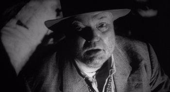 Movie still from “Get Shorty” (1995), directed by Barry Sonnenfeld – An older man wearing a hat and a jacket; Close Up shot, Low angle