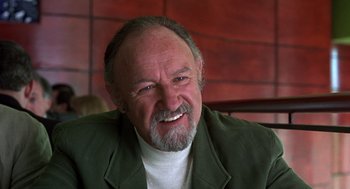 Movie still from “Get Shorty” (1995), directed by Barry Sonnenfeld – An older man with a goatee and a beard smiling; Close Up shot, Low angle