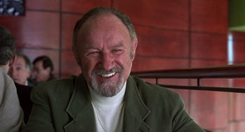 Movie still from “Get Shorty” (1995), directed by Barry Sonnenfeld – An older man with a goatee smiling for the camera; Close Up shot, Low angle