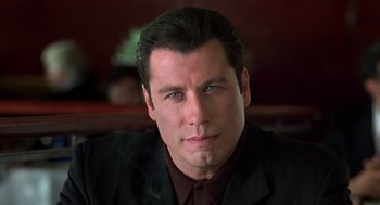 Movie still from “Get Shorty” (1995), directed by Barry Sonnenfeld – A person wearing a suit and tie; Close Up shot, Low angle