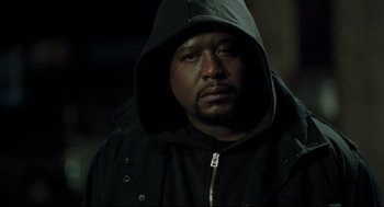 Movie still from “Ghost Dog: The Way of the Samurai” (1999), directed by Jim Jarmusch – A man wearing a black hooded jacket and looking at the camera; Close Up shot, Low angle