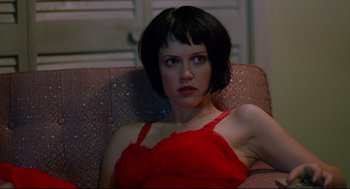 Movie still from “Ghost Dog: The Way of the Samurai” (1999), directed by Jim Jarmusch – A woman sitting on a couch wearing a red dress; Close Up shot, Low angle
