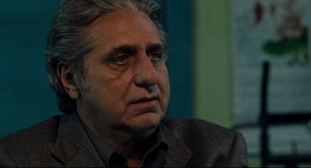 Movie still from “Ghost Dog: The Way of the Samurai” (1999), directed by Jim Jarmusch – An older man with grey hair looking at the camera; Close Up shot, Over the shoulder angle