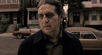 Movie still from “Ghost Dog: The Way of the Samurai” (1999), directed by Jim Jarmusch – An older man in a brown shirt and a black jacket; Close Up shot, Low angle