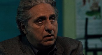 Movie still from “Ghost Dog: The Way of the Samurai” (1999), directed by Jim Jarmusch – An older man in a suit and tie looking to his left; Close Up shot, Over the shoulder angle