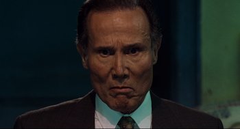 Movie still from “Ghost Dog: The Way of the Samurai” (1999), directed by Jim Jarmusch – An older man in a suit and tie; Close Up shot, Low angle