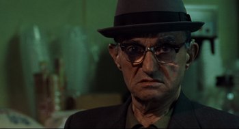 Movie still from “Ghost Dog: The Way of the Samurai” (1999), directed by Jim Jarmusch – An older man wearing a hat and glasses; Close Up shot, Low angle