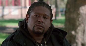 Movie still from “Ghost Dog: The Way of the Samurai” (1999), directed by Jim Jarmusch – A person wearing a jacket; Close Up shot, Over the shoulder angle