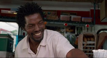 Movie still from “Ghost Dog: The Way of the Samurai” (1999), directed by Jim Jarmusch – A person smiling with his eyes closed; Close Up shot, Low angle