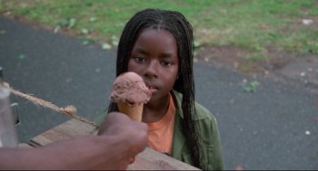 Movie still from “Ghost Dog: The Way of the Samurai” (1999), directed by Jim Jarmusch – A young girl eating an ice cream cone; Close Up shot, Over the shoulder angle