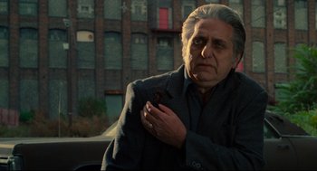 Movie still from “Ghost Dog: The Way of the Samurai” (1999), directed by Jim Jarmusch – An older man holding a bird in his hand; Close Up shot, Over the shoulder angle