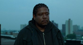 Movie still from “Ghost Dog: The Way of the Samurai” (1999), directed by Jim Jarmusch – A person wearing a jacket; Close Up shot, Low angle