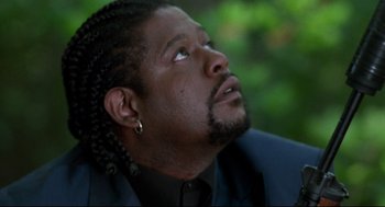 Movie still from “Ghost Dog: The Way of the Samurai” (1999), directed by Jim Jarmusch – A person wearing a suit; Close Up shot, Low angle