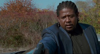 Movie still from “Ghost Dog: The Way of the Samurai” (1999), directed by Jim Jarmusch – A person with dreadlocks; Close Up shot, Low angle