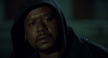 Movie still from “Ghost Dog: The Way of the Samurai” (1999), directed by Jim Jarmusch – A person wearing a hooded jacket; Close Up shot, Low angle