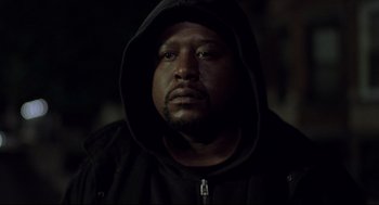 Movie still from “Ghost Dog: The Way of the Samurai” (1999), directed by Jim Jarmusch – A person wearing a hooded sweatshirt; Close Up shot, Low angle