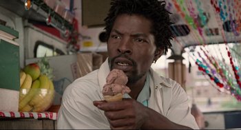 Movie still from “Ghost Dog: The Way of the Samurai” (1999), directed by Jim Jarmusch – A man holding a scoop of ice cream in his hand; Close Up shot, Over the shoulder angle