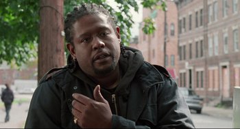 Movie still from “Ghost Dog: The Way of the Samurai” (1999), directed by Jim Jarmusch – A man with a beard and a jacket on; Close Up shot, Over the shoulder angle