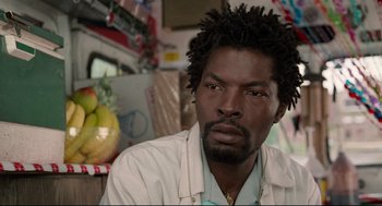 Movie still from “Ghost Dog: The Way of the Samurai” (1999), directed by Jim Jarmusch – A person wearing a white shirt; Close Up shot, Over the shoulder angle