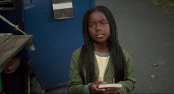 Movie still from “Ghost Dog: The Way of the Samurai” (1999), directed by Jim Jarmusch – A young girl holding a notebook and pencil; Close Up shot, High angle