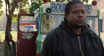 Movie still from “Ghost Dog: The Way of the Samurai” (1999), directed by Jim Jarmusch – A man standing in front of an ice cream truck; Close Up shot, Over the shoulder angle