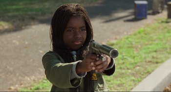 Movie still from “Ghost Dog: The Way of the Samurai” (1999), directed by Jim Jarmusch – A little girl holding a gun in her hands; Close Up shot, High angle