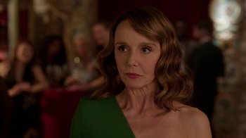 Movie still from “Emily in Paris” (2020), created by Darren Star – A person wearing a green dress; Close Up shot, Over the shoulder angle