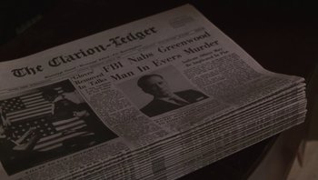 Movie still from “Ghosts of Mississippi” (1996), directed by Rob Reiner – An old newspaper with a picture of a man in a black suit; Extreme Close Up shot, High angle
