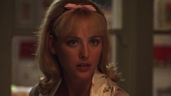 Movie still from “Ghosts of Mississippi” (1996), directed by Rob Reiner – A person wearing a shirt with a bow; Close Up shot, Over the shoulder angle