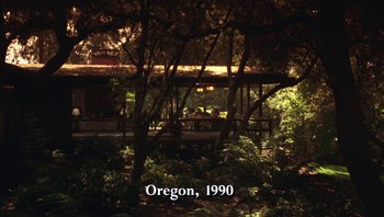 Movie still from “Ghosts of Mississippi” (1996), directed by Rob Reiner – People sitting on a bench in a forest; Extreme Wide shot, High angle