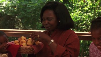 Movie still from “Ghosts of Mississippi” (1996), directed by Rob Reiner – A woman holding a basket full of mushrooms; Close Up shot, Low angle