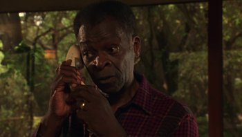 Movie still from “Ghosts of Mississippi” (1996), directed by Rob Reiner – An older man holding a phone up to his ear; Close Up shot, Low angle