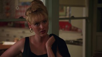 Movie still from “Ghosts of Mississippi” (1996), directed by Rob Reiner – A woman in a black top is looking at the camera; Close Up shot, Over the shoulder angle