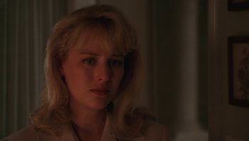 Movie still from “Ghosts of Mississippi” (1996), directed by Rob Reiner – A woman with blonde hair and a white shirt; Close Up shot, Over the shoulder angle
