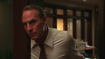 Movie still from “Ghosts of Mississippi” (1996), directed by Rob Reiner – A man wearing a white shirt and a brown tie; Close Up shot, Low angle