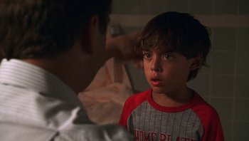 Movie still from “Ghosts of Mississippi” (1996), directed by Rob Reiner – A young boy is being comforted by his father; Close Up shot, Over the shoulder angle