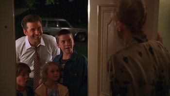 Movie still from “Ghosts of Mississippi” (1996), directed by Rob Reiner – A group of people standing in front of a door; Medium shot, Over the shoulder angle