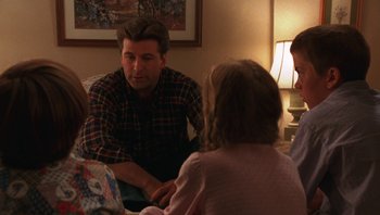 Movie still from “Ghosts of Mississippi” (1996), directed by Rob Reiner – A group of people sitting around a table talking; Medium shot, Over the shoulder angle