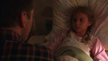 Movie still from “Ghosts of Mississippi” (1996), directed by Rob Reiner – A little girl laying in a bed next to a man; Medium shot, High angle