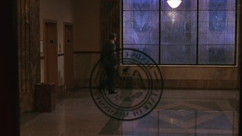 Movie still from “Ghosts of Mississippi” (1996), directed by Rob Reiner – A man walking in front of a window in a building; Extreme Wide shot, Low angle