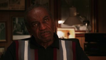 Movie still from “Ghosts of Mississippi” (1996), directed by Rob Reiner – An older man wearing a striped shirt looking at the camera; Close Up shot, Low angle