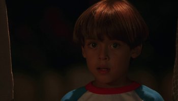 Movie still from “Ghosts of Mississippi” (1996), directed by Rob Reiner – A young boy is looking at the camera; Close Up shot, High angle