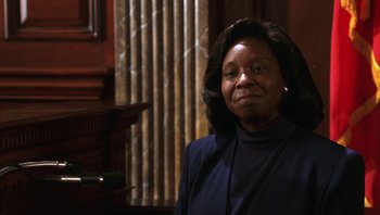 Movie still from “Ghosts of Mississippi” (1996), directed by Rob Reiner – An older woman in a blue jacket is posing for a picture; Close Up shot, Low angle