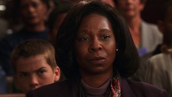 Movie still from “Ghosts of Mississippi” (1996), directed by Rob Reiner – An older woman is looking directly at the camera; Close Up shot, Over the shoulder angle