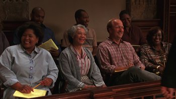 Movie still from “Ghosts of Mississippi” (1996), directed by Rob Reiner – A group of people sitting in front of each other; Medium shot, High angle