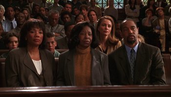 Movie still from “Ghosts of Mississippi” (1996), directed by Rob Reiner – A group of people sitting in front of a crowd; Medium shot, High angle